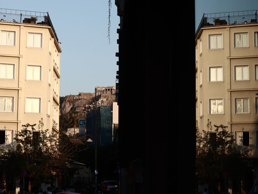Acropolis framed between buildings in evening light